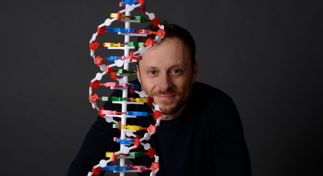 Hannes Schroeder poses beside a DNA-helix figure.