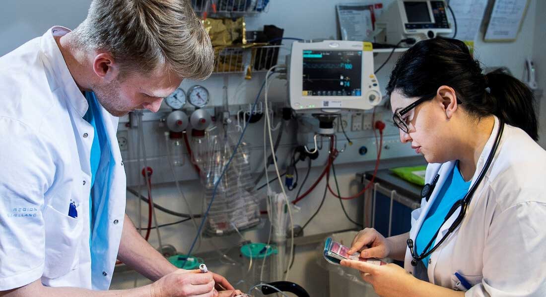 Two medical doctors examining measuring devices