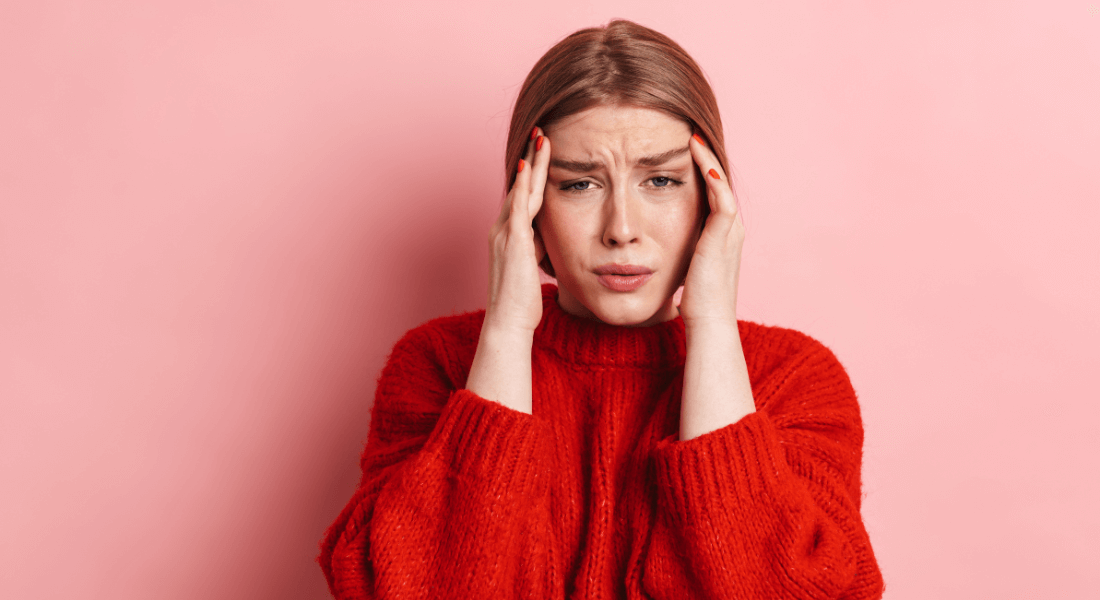 Person with headache holding their head