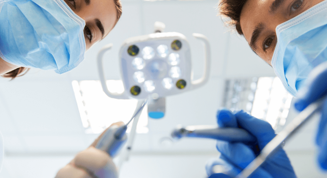 Dentist looking at patient